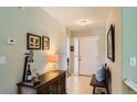 Inviting entryway featuring tile flooring, decorative furnishings, and a well-lit interior at 6114 Salvia Ln, Arvada, CO 80403