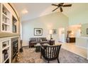 Bright living room with vaulted ceilings, a cozy fireplace, and a comfortable seating arrangement at 6114 Salvia Ln, Arvada, CO 80403