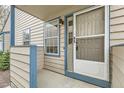 Inviting front entryway with a storm door, window, and traditional siding at 1773 S Union Blvd, Lakewood, CO 80228