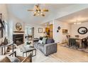Cozy living room with fireplace, wood floors, ceiling fan, and open floor plan at 1773 S Union Blvd, Lakewood, CO 80228