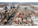 Aerial view of property in urban area with neighborhood, garage, and city skyline in the background at 1556 Osceola St, Denver, CO 80204