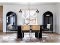 Dining room with a modern table, chairs, black shelving, decorative rug and a large window with natural light at 8309 W 69Th Way, Arvada, CO 80004