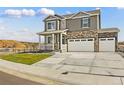 Two-story house with a two-car garage and a landscaped front yard at 7548 E 159Th Pl, Thornton, CO 80602