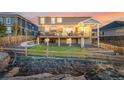 Beautiful backyard featuring a deck, grass, and a wooden fence at 1825 Wingfeather Ln, Castle Rock, CO 80108