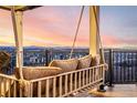 Balcony with a swing overlooking scenic views of the mountains and city at 1825 Wingfeather Ln, Castle Rock, CO 80108