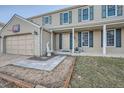 House exterior featuring a two-car garage and a landscaped front yard at 1584 S Vaughn Cir, Aurora, CO 80012