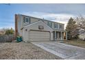 Two-story house with attached garage, landscaping, and basketball hoop at 1584 S Vaughn Cir, Aurora, CO 80012