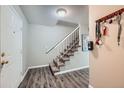 Clean entryway with a staircase leading upstairs and wood-look flooring at 1584 S Vaughn Cir, Aurora, CO 80012