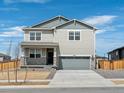 Two-story house with gray siding, stone accents, and a two-car garage at 8888 Salida St, Commerce City, CO 80022