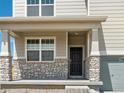Inviting front entrance with stone accents and a dark-stained front door at 8888 Salida St, Commerce City, CO 80022