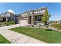 Two-story home with stone accents, well-manicured lawn, and a long driveway at 23883 E Minnow Cir, Aurora, CO 80016