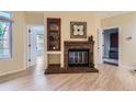 Cozy living room featuring a brick fireplace and unique built-in shelving for a touch of elegance at 3040 W Prentice Ave # B, Littleton, CO 80123