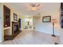 Open living space with wood floors and a brick fireplace, seamlessly flowing into the dining area at 3040 W Prentice Ave # B, Littleton, CO 80123