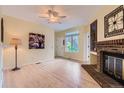 Bright living room boasts wood floors, a decorative fireplace, and a sunny window view at 3040 W Prentice Ave # B, Littleton, CO 80123