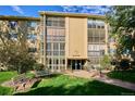 Building exterior with beautiful garden and lawn at 13500 E Cornell Ave # 302, Aurora, CO 80014
