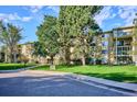 Well-maintained building with mature trees and landscaping at 13500 E Cornell Ave # 302, Aurora, CO 80014