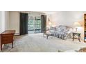 Living room featuring neutral carpet and sliding glass doors at 13500 E Cornell Ave # 302, Aurora, CO 80014