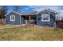 Ranch style home features a freshly painted exterior, landscaping and a welcoming front yard at 7195 W 24Th Ave, Lakewood, CO 80214