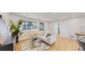 Bright and airy living room with hardwood floors, neutral decor, and plenty of natural light at 7195 W 24Th Ave, Lakewood, CO 80214