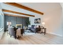 Comfortable living room with a decorative brick fireplace, wood beam ceiling, and contemporary decor at 1251 S Yosemite Way # 92, Denver, CO 80247