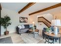 Bright living room showcasing stylish furniture, hardwood floors, and a staircase at 1251 S Yosemite Way # 92, Denver, CO 80247