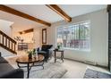 Inviting living room with natural light, wood beams, and an open layout at 1251 S Yosemite Way # 92, Denver, CO 80247