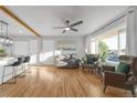 Open concept living room with kitchen island, hardwood floors, and oversized windows at 709 S Wolcott Ct, Denver, CO 80219