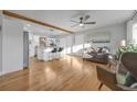 Open concept living room and kitchen featuring hardwood floors and natural lighting at 709 S Wolcott Ct, Denver, CO 80219