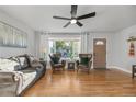 Cozy living room area with comfortable seating, hardwood floors, and a large window at 709 S Wolcott Ct, Denver, CO 80219