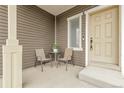 Inviting front porch with seating, perfect for relaxing outdoors at 4574 Walden St, Denver, CO 80249