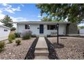 Ranch style home with a well-maintained front yard and walkway at 1478 S Krameria St, Denver, CO 80224