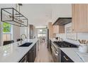 Bright kitchen with white quartz counters and dark cabinetry at 3916 N Mariposa St, Denver, CO 80211