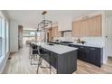 Spacious kitchen with island, stainless steel appliances, and light wood cabinets at 3916 N Mariposa St, Denver, CO 80211