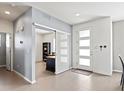 Inviting entryway featuring sleek tile flooring, a sliding glass door, and a modern front door with glass panels at 3368 Cranston Cir, Highlands Ranch, CO 80126