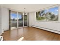 Bright dining room featuring hardwood floors and sliding glass doors to a balcony with city views at 740 N Pearl St # 203, Denver, CO 80203