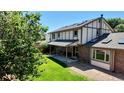 Expansive backyard features a covered patio, lush lawn, and mature landscaping, perfect for outdoor entertaining at 16639 E Berry Ln, Centennial, CO 80015