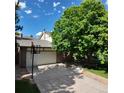 Spacious driveway leading to a two-car garage, framed by mature trees and a basketball hoop at 16639 E Berry Ln, Centennial, CO 80015