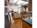 Functional kitchen design featuring dark countertops and light wood cabinets at 16639 E Berry Ln, Centennial, CO 80015