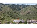 This is a top-down aerial of homes with landscaping and mountain views at 6835 Surrey Trl, Littleton, CO 80125