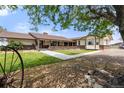 Ranch-style home with brick accents, a covered porch, and walkway through the landscaped yard at 1851 E 138Th Ave, Brighton, CO 80602
