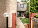 Charming backyard space with string lights, artificial turf and sliding glass door at 1233 S Yosemite Way # 74, Denver, CO 80247