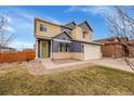 Charming two-story home featuring blue and beige siding, a two-car garage, and well-maintained landscaping at 1706 Ghost Dance Cir, Castle Rock, CO 80108