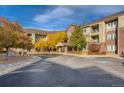 Attractive building exterior with fall foliage and accessible parking, showcasing a well-maintained facade at 2896 W Riverwalk Cir # A102, Littleton, CO 80123