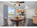 Cozy dining area with a round table, comfortable chairs, and a modern ceiling fan at 153 S Pierce St, Lakewood, CO 80226