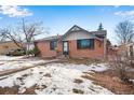 Brick ranch home with attached garage and snowy front yard at 153 S Pierce St, Lakewood, CO 80226