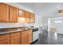 Functional kitchen with ample cabinet space and stainless steel sink overlooking the dining area at 153 S Pierce St, Lakewood, CO 80226