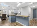 Open concept kitchen with wood countertops, and eating area adjacent to the living area at 4301 S Pierce St # 6D, Littleton, CO 80123