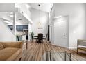 Bright and airy living room with high ceilings, hardwood floors, dining area, and abundant natural light at 4301 S Pierce St # 6D, Littleton, CO 80123