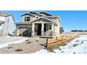 Two-story house with light-colored siding, a two-car garage, and a wooden fence at 210 Paloma Way, Elizabeth, CO 80107