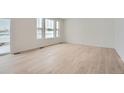 Bright living room featuring light hardwood floors and large windows at 210 Paloma Way, Elizabeth, CO 80107